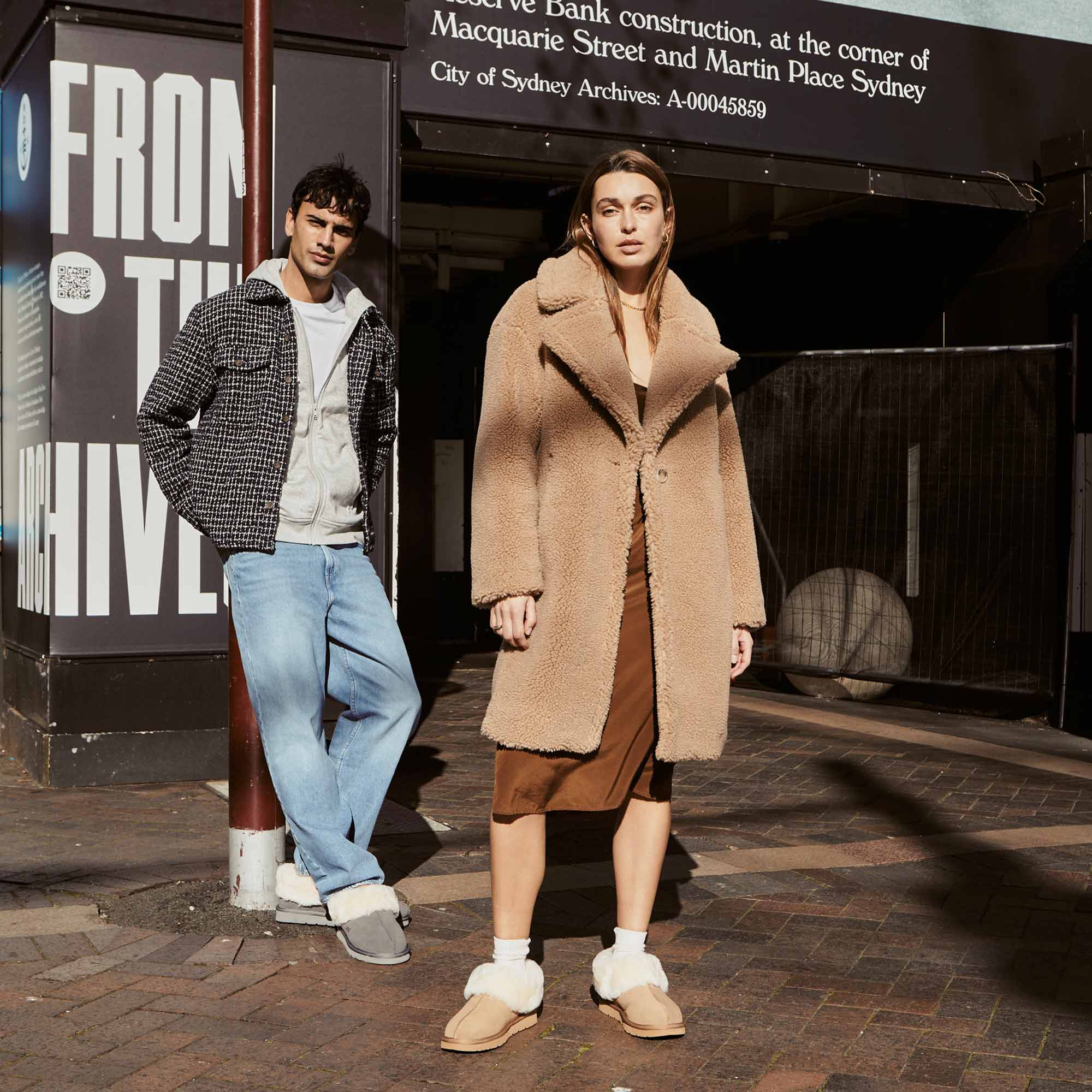 a couple hanging out in sydney wearing layers and UGG slippers