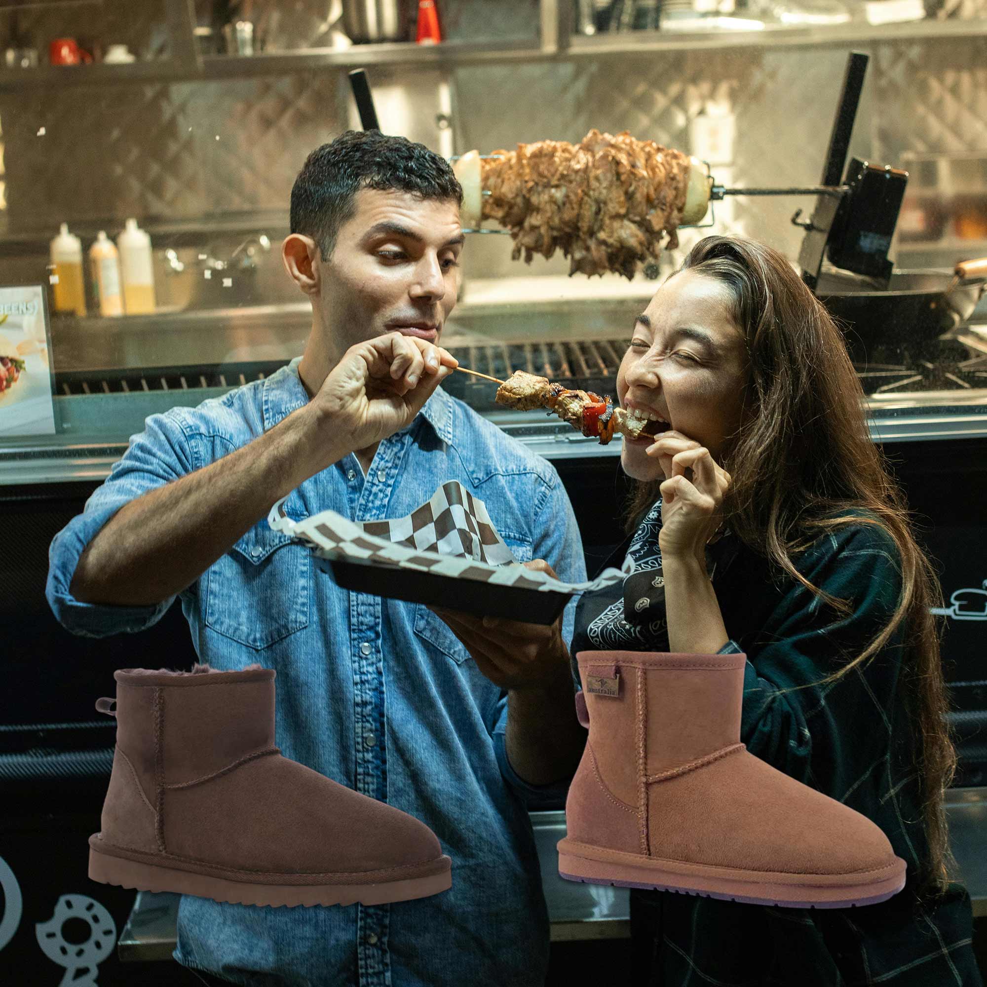couple eating at a night market while wearing UGG boots