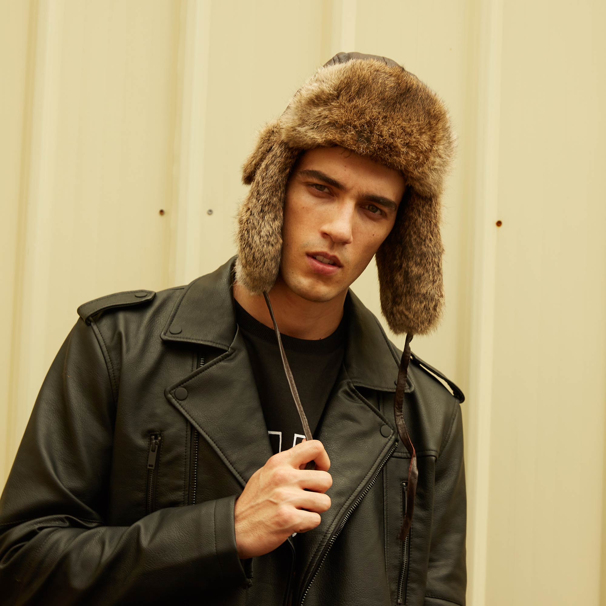 man-wearing-black-leather-and-ugg-aviator-leather-hat-with-rabbit-fur