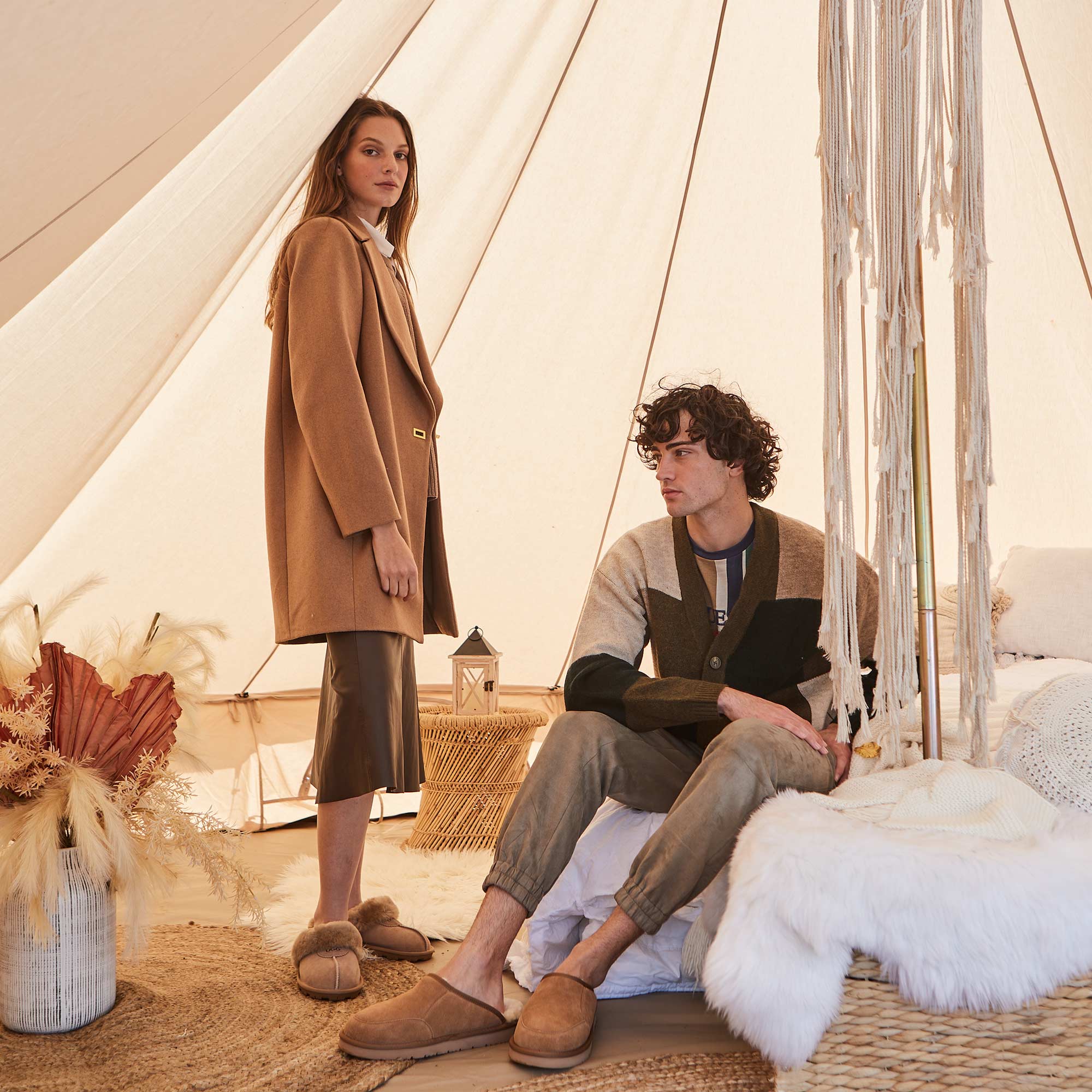 man and woman wearing UGG slippers