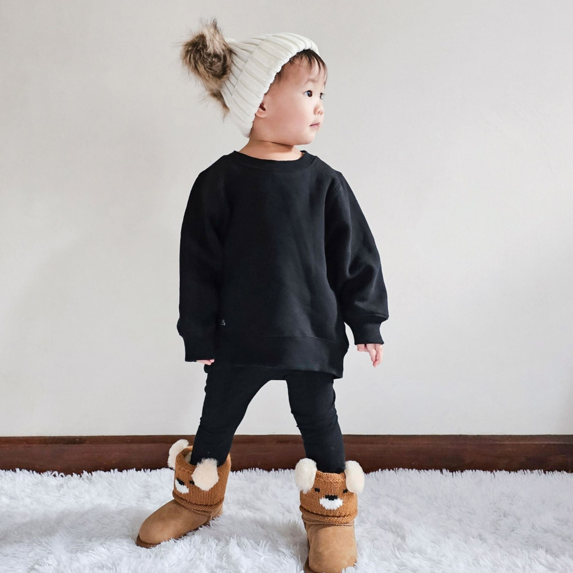 toddler wearing UGG boots that are easy to slip on and off