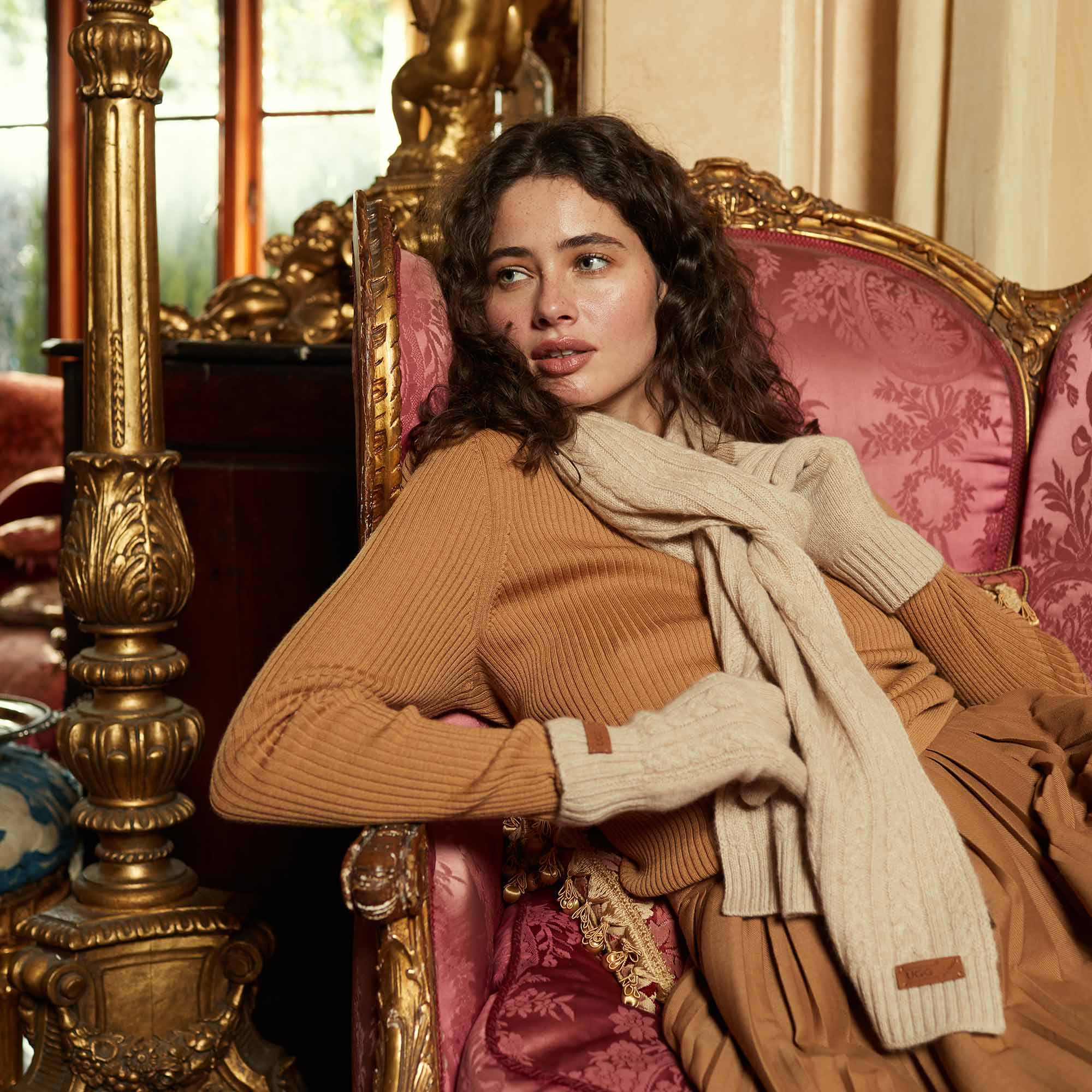 woman at home wearing a long sleeve and UGG scarf