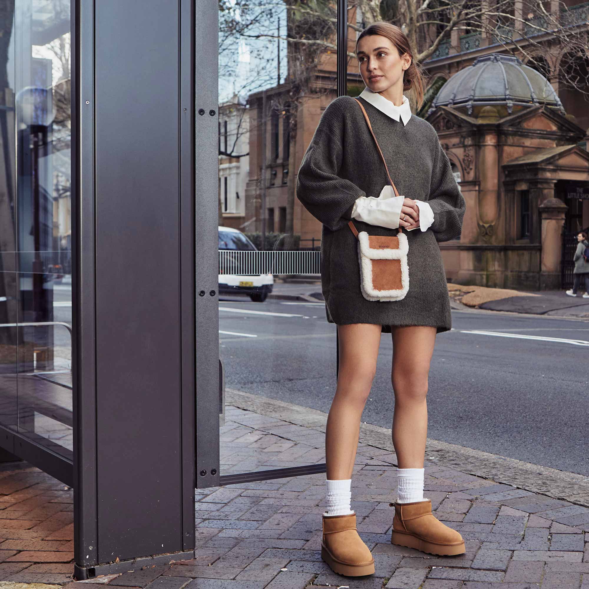 woman at the city of Australia matching her platform UGG boots with UGG bag
