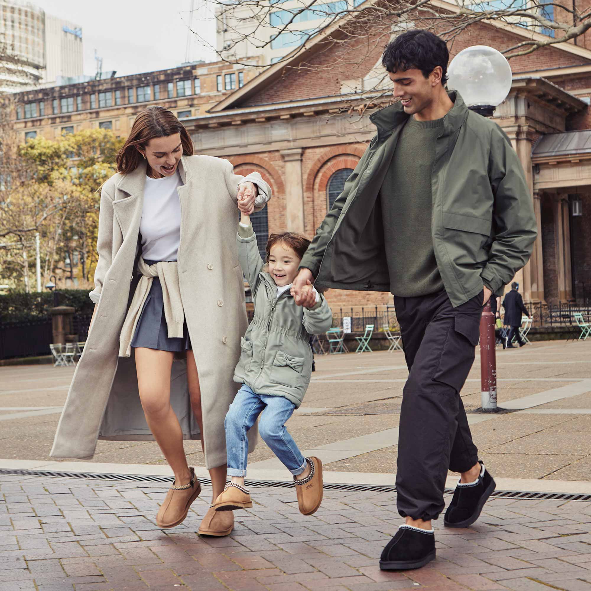 family-of-three-enjoying-their-hang-out-at-the-city-and-wearing-cosy-ugg-slippers