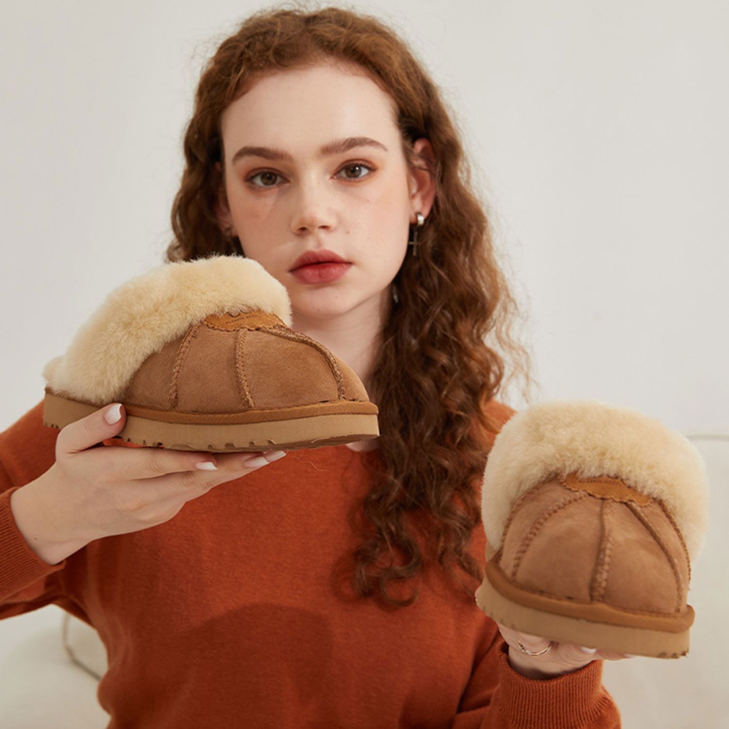Model Holding a Pair of UGG Boots