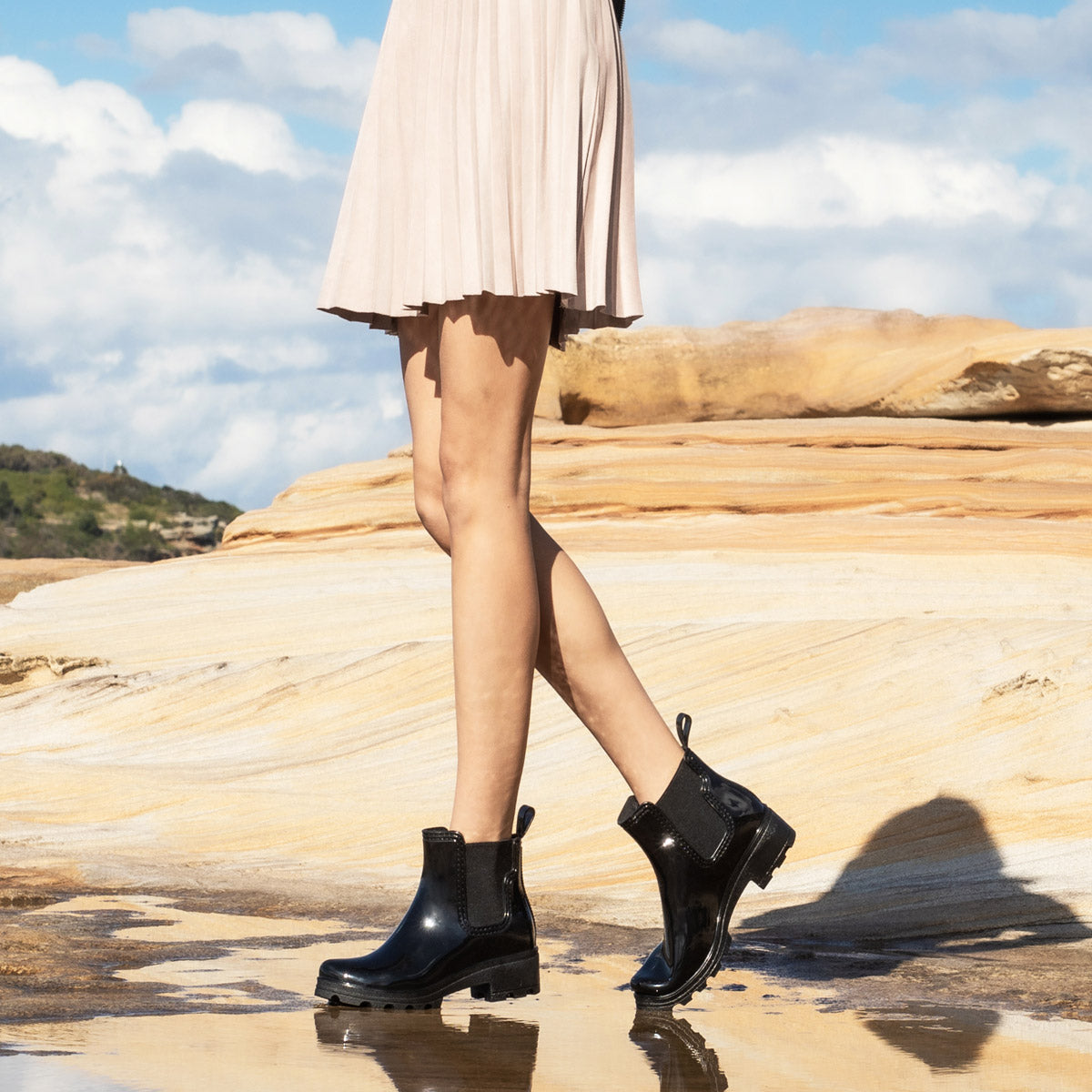 a girl wearing a mini skirt with water proof UGG boots