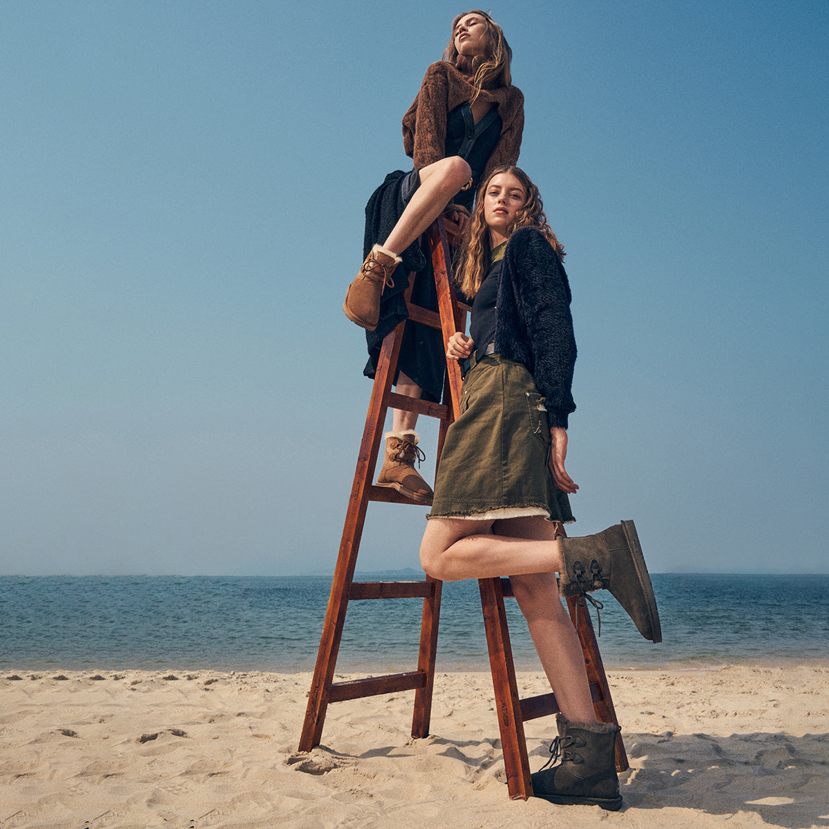 two girls wearing UGG boots at the beach during summer